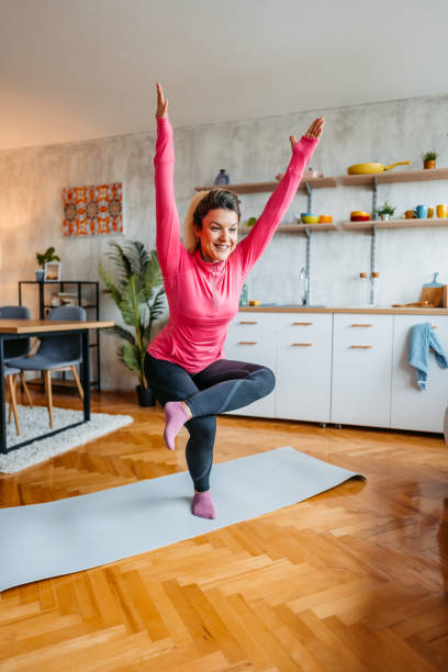 istock Young Woman Doing Yoga At Home 1431004874