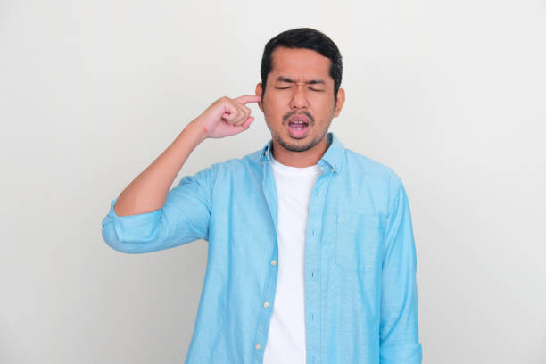 istock Adult Asian man showing pain expression when putting finger inside his ear 1431005875