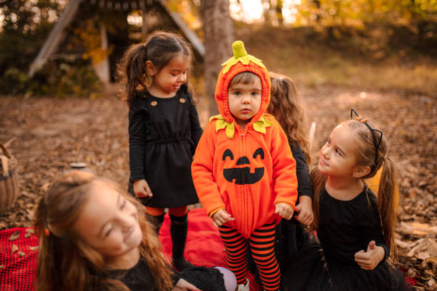 istock Little girls dressed playing as witch at Halloween in the forest. 1431007070