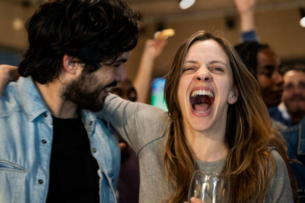 istock Group of friends having fun and celebrating at a crowded bar 1431007120