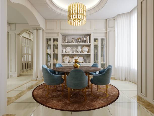 istock Dining room with brown round table and blue upholstered chairs and shelves with kitchen decor and brown carpet. 1431010217