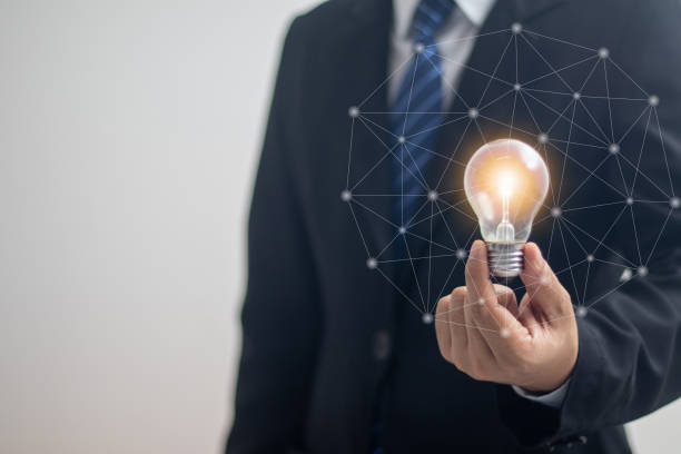 istock businessman holding a bright light bulb 1431011328