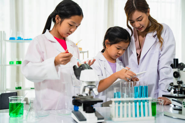 istock Teacher is teaching chemistry to students a teacher is teaching students to take notes of results experiment. 1431015472