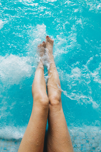 POV of female feet in the spa pool