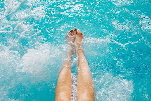 POV of female feet in the spa pool