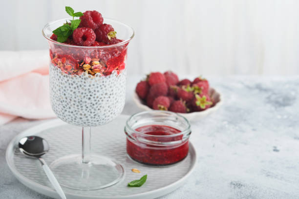 istock Chia pudding. Healthy vanilla chia pudding in glass with fresh raspberries and mint on white background. Vegan healthy breakfast. 1431017912