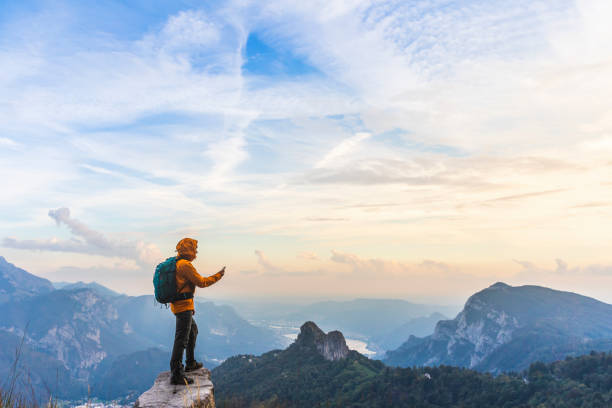 hiker on top of the mountain using smartphone app - argentina landscape scenics south america imagens e fotografias de stock