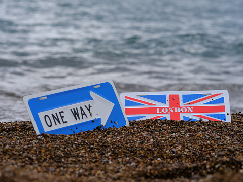 one way and  London city sign on the beach