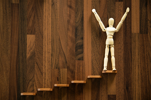 Wooden men  on the stairs