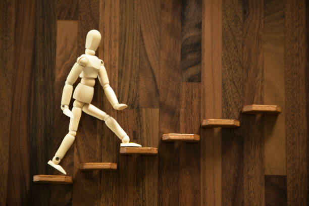 istock Wooden men walking up stairs 1431029649