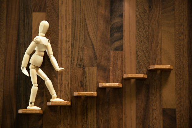 istock Wooden men walking up stairs 1431029749