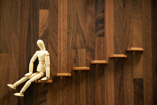 Wooden men sitting on the stairs