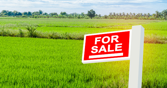 Land for sale sign, real estate residence purchase payment, home loan concept.