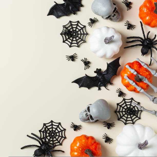 istock Halloween greeting card with bats, spiderweb, spider, skull and pumpkins 1431032240
