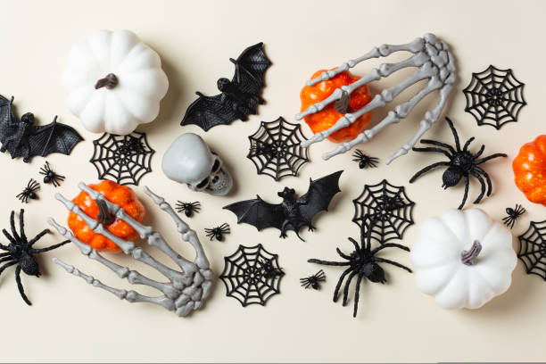 istock Halloween greeting card with bats, spiderweb, spider, skull and pumpkins 1431032449