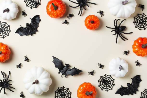 istock Halloween greeting card with bats, spiderweb, spider, skull and pumpkins 1431032730