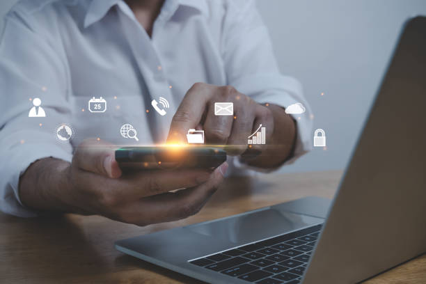 istock business man hand touching on mobile smart phone and computer with virtual social media icon diagram, contact us, business finance, internet data technology, digital marketing, social network concept 1431035835