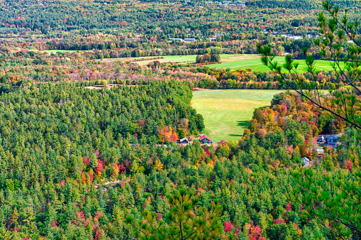 Fall Foliage across the rolling hills of Vermont. Peak fall color on a beautiful sunny day in New England.