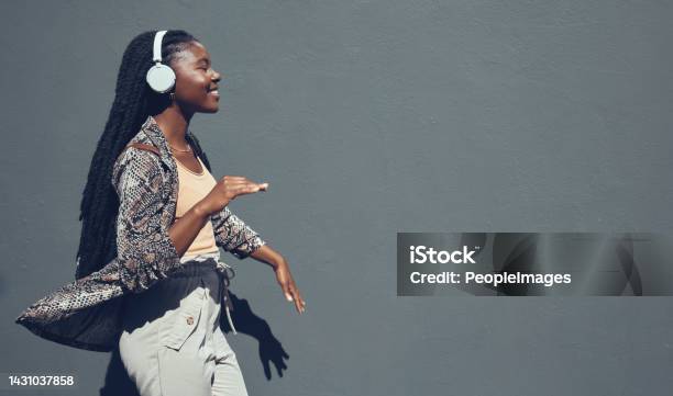 Music University And College Dance Student Dancing And Listening To Podcast Or Radio On Headphone Walking Past Campus Copy Space Banner For Education Mock Up Content On Grey Wall Background Stock Photo - Download Image Now