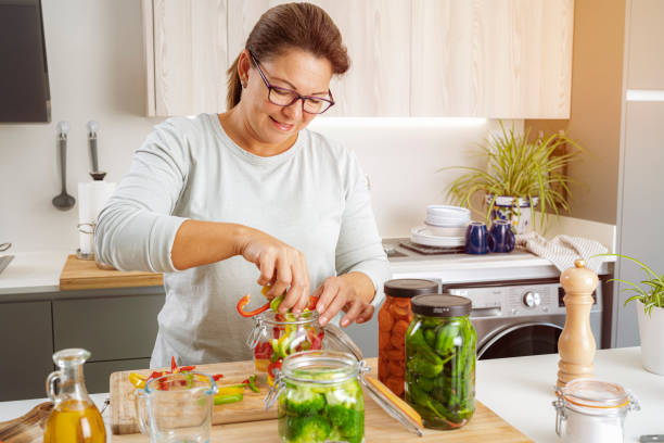 istock Woman canning vegetables at home 1431038740