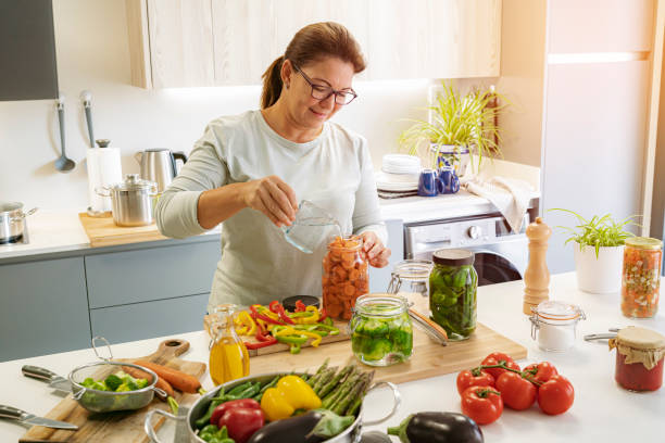 istock Woman pickles vegetables at home 1431038751