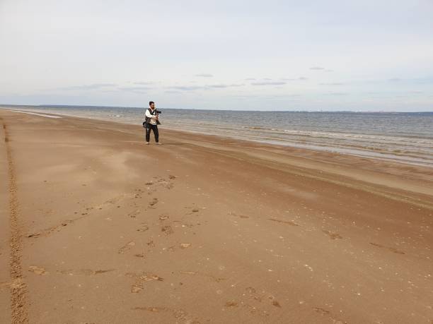 istock a man takes a video on a sandy beach in 1431039301