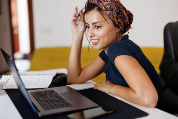 istock Young woman studying at home with laptop 1431039352