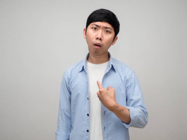 istock Confused man blue shirt point finger at himself isolated 1431043410
