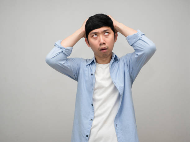 istock Asian man hold his head feels dizzy with working isolated 1431043448