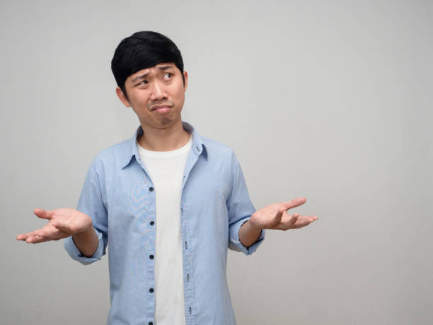 istock Young asian man blue short posing hands up feels doubt copy space 1431043486