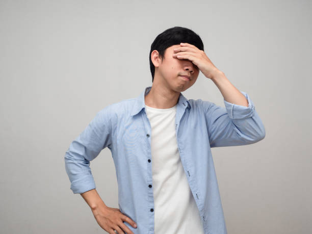 istock Worker man blue shirt hold his head feels dizzy isolated 1431043502