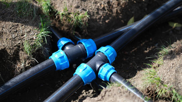 istock Black long pipe lies and tee adapter in dug-out earth closeup 1431043718