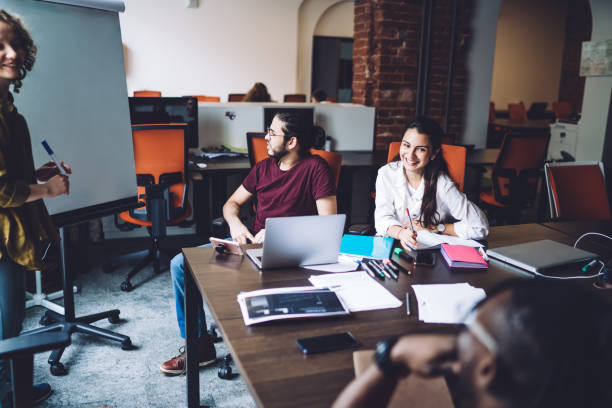 istock Cheerful multiethnic employees during conference in modern open space office 1431046479