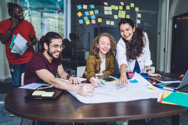 istock Joyful employee having fun pointing at sketch with partners 1431046512