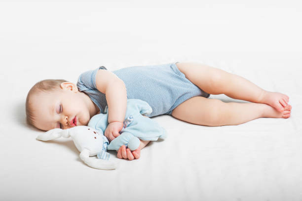 Little baby girl sleeps with open arms