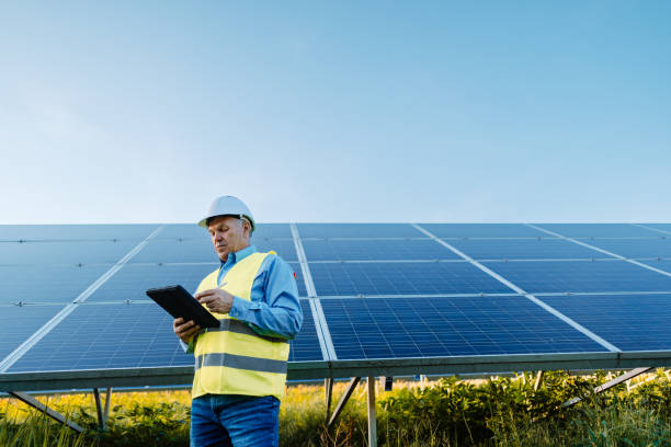 istock Elderly engineer is checking with tablet an operation of sun and cleanliness on field 1431048688