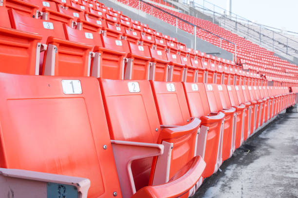 istock Empty orange seats at stadium,Rows of seat on a soccer stadium 1431048768