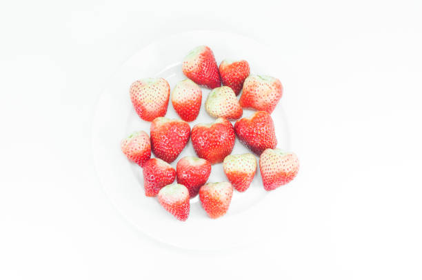 Fresh strawberries on a wicker table.