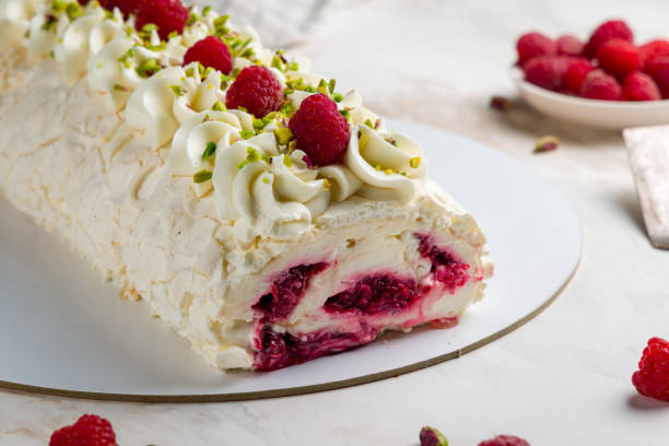 istock meringue roll with raspberries and pistachios on white marble table macro close up 1431049058