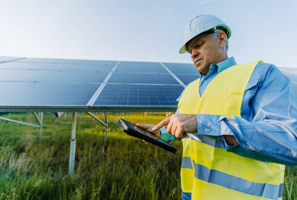 istock Solar engineer working with digital tablet at renewable energy farm. Alternative Eco energy concept 1431049875