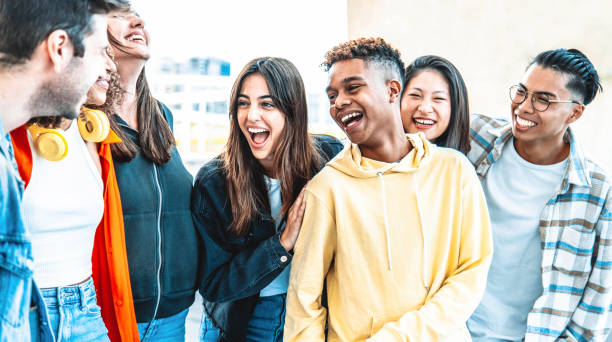 istock Multicultural best friends having fun hanging out together - Happy young people laughing walking on city street - International students talking outside school in college campus - Friendship concept 1431051617
