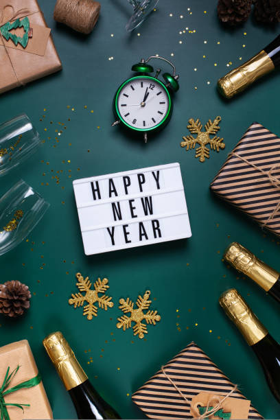 istock Happy New Year greeting card with champagne and gift boxes 1431053590