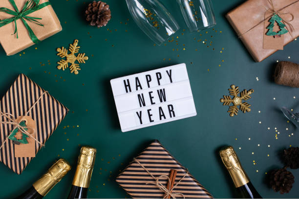 istock Happy New Year greeting card with champagne and gift boxes 1431053783