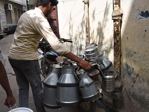Uttarakhand, Roorkee – September 15, 2022: People in the Muslim area of the city, milk seller delivers  fresh milk directly to customers' homes