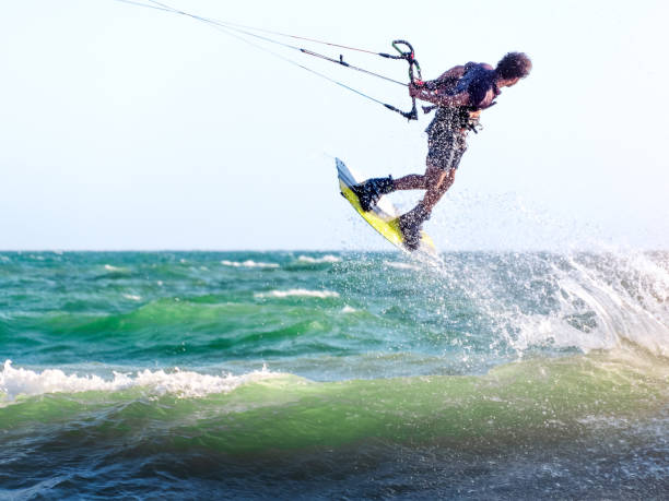 istock Young man kite boarder jumps over the sea at sunset. Selective focus. 1431055274
