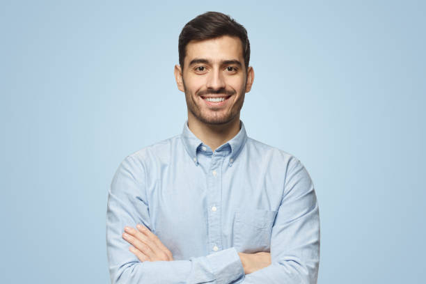 istock Smiling businessman in blue shirt on blue background 1431057873