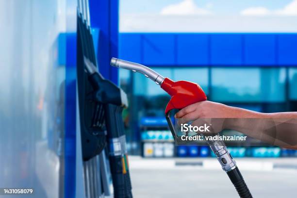 Man Holds A Refueling Gun In His Hand For Refueling Cars Gas Station With Diesel And Gasoline Fuel Closeup Stock Photo - Download Image Now