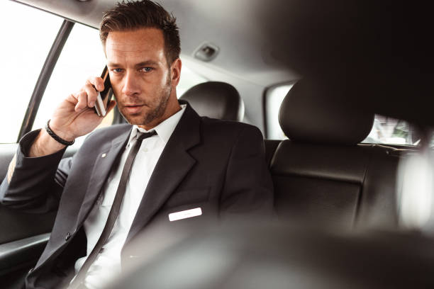 istock business man in a cab checking the time 1431060864
