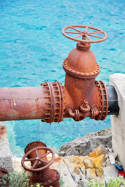 istock Pipes and valve on the sea coast all in rust 1431063738