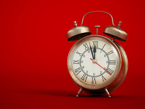 istock Vintage analogue alarm clock on red background with soft shadows 1431066161